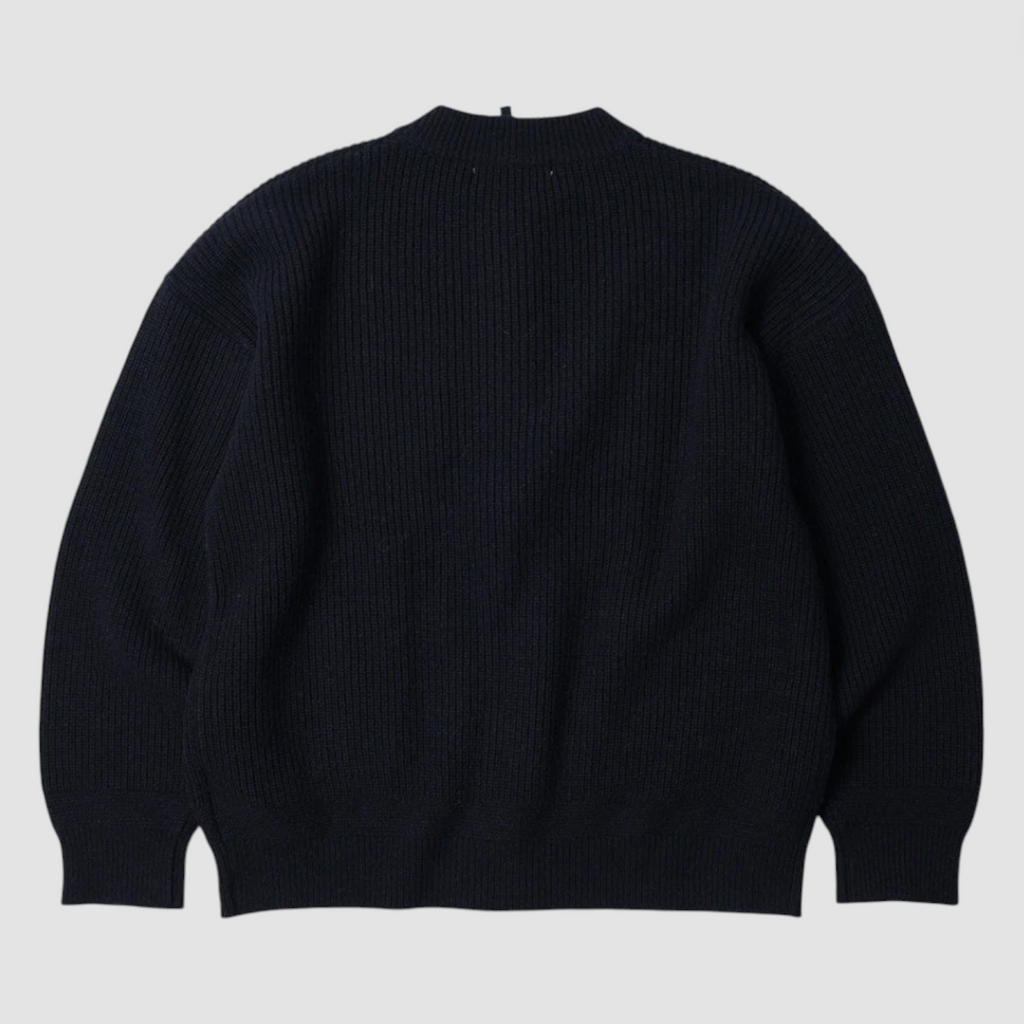 Navy sweater on a light gray background.
