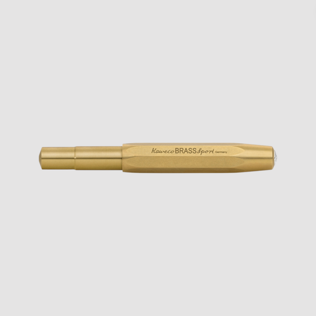 High-quality brass rollerball pen with silver accents, featuring a compact design, smooth writing, and natural patina development over time.