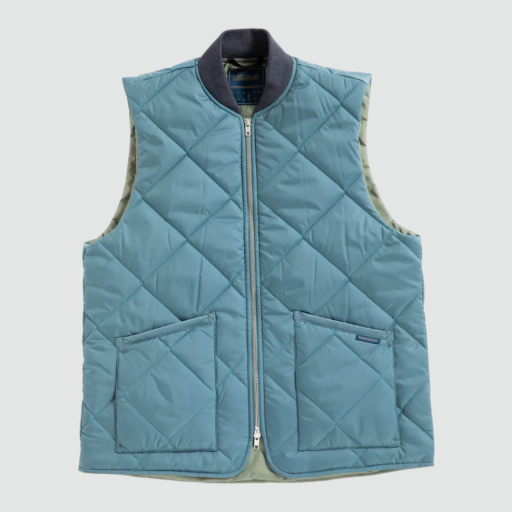 Quilted bomber gilet in Tapestry Blue with a two-way zip, ribbed collar, and two patch pockets, made with lightweight yet warm wadding.