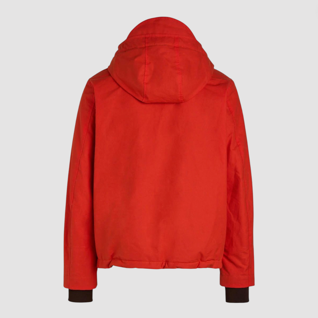 Orange wax coat with hood on light grey background.