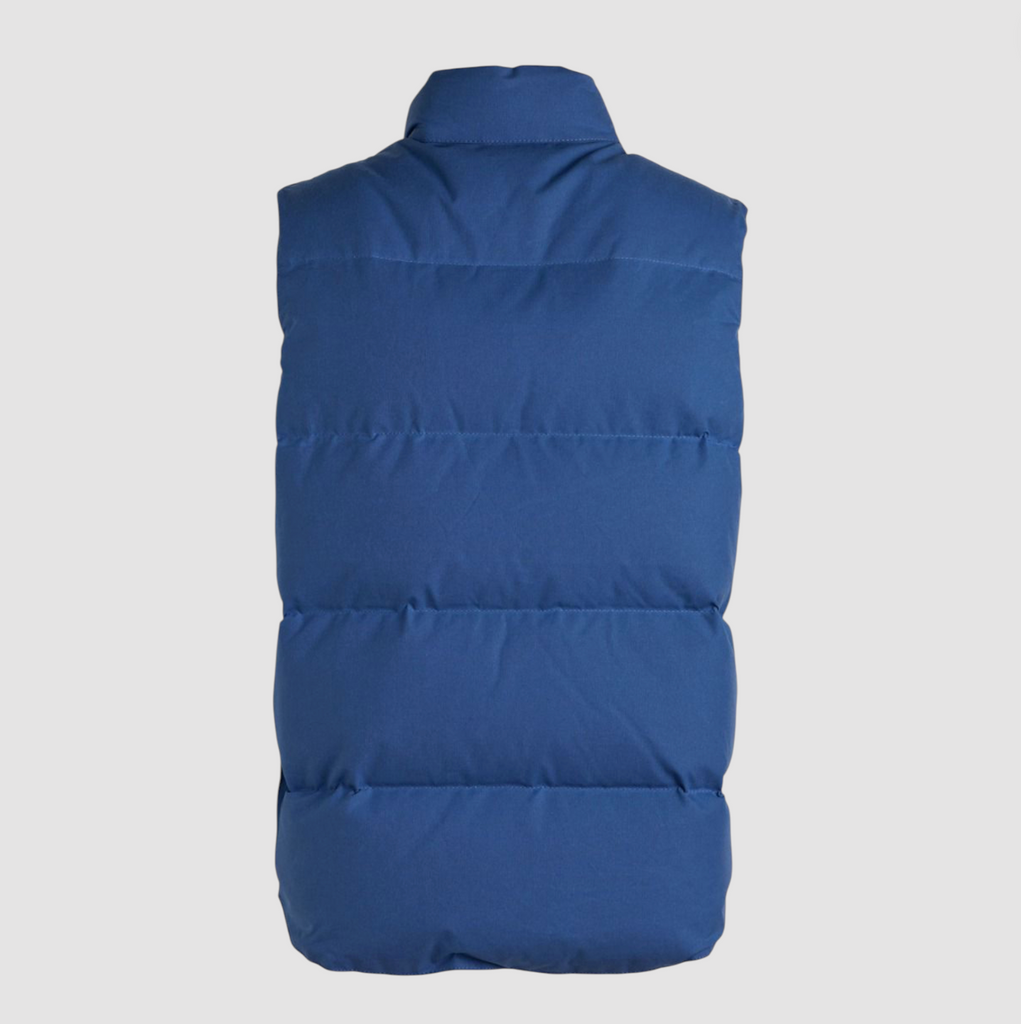 Blue puffer vest on a light grey background. 