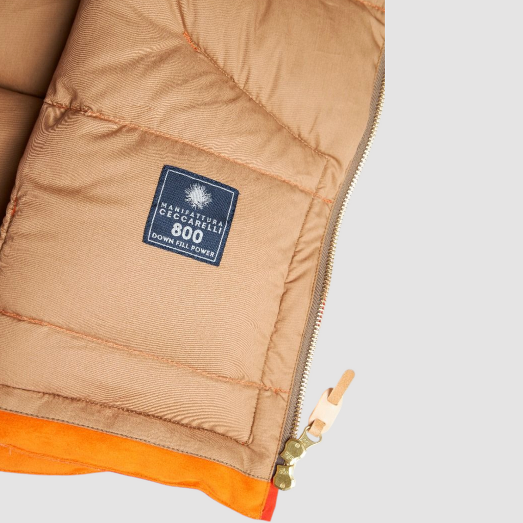 Orange goose down vest with water-repellent dry cotton shell, 90/10 white goose down fill, zip closure, snap button collar, and leather details.