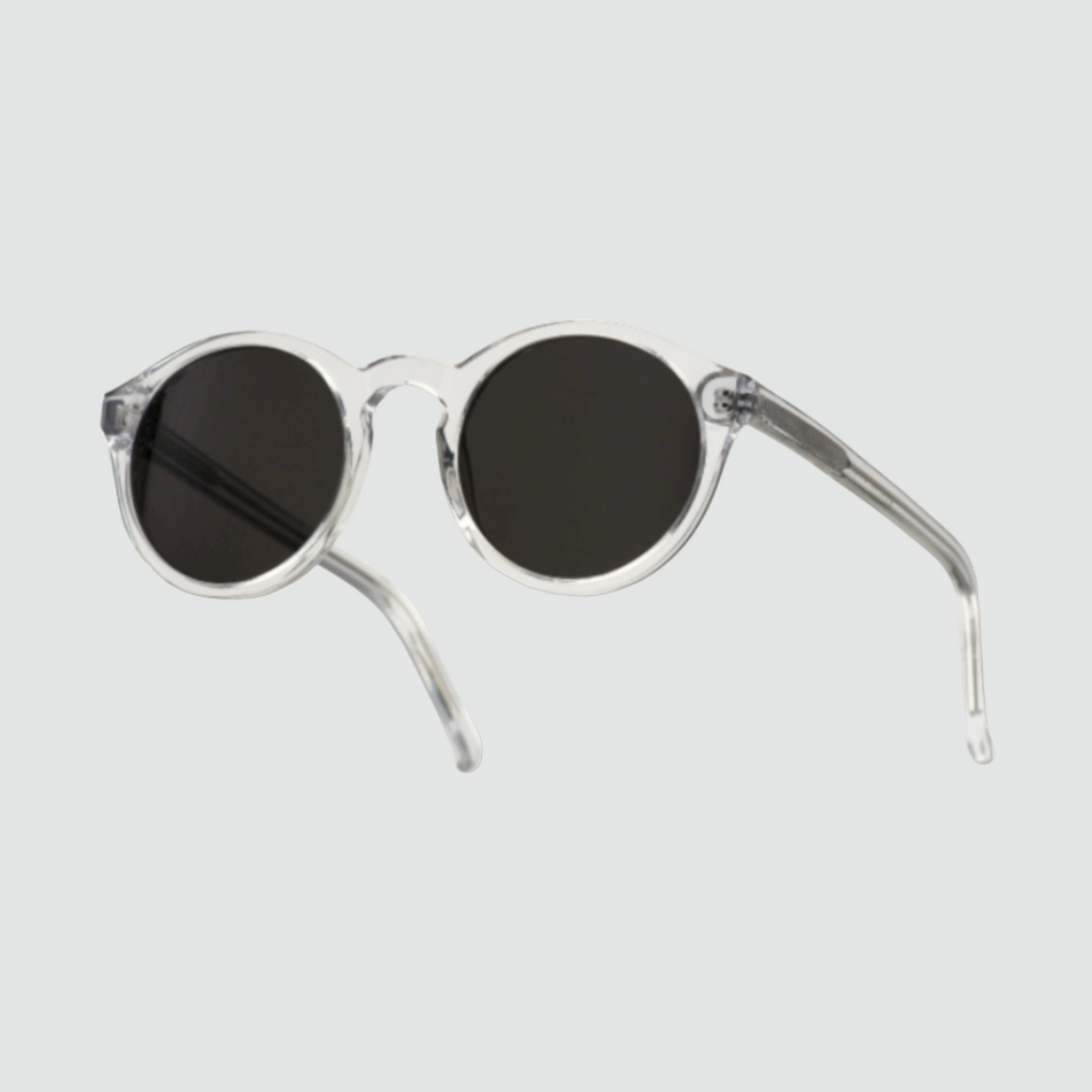 Monokel Barstow Crystal Sunglasses with grey lenses, handcrafted from organic acetate, featuring a keyhole nosebridge and Carl Zeiss Vision lenses.