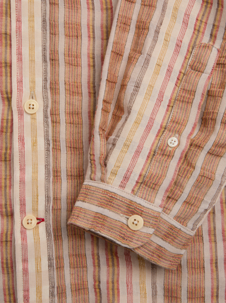 Multi-colored oversized long-sleeve shirt in lightweight cotton-linen seersucker, featuring a spear collar, front patch pocket, curved hem, and contrast gusset.