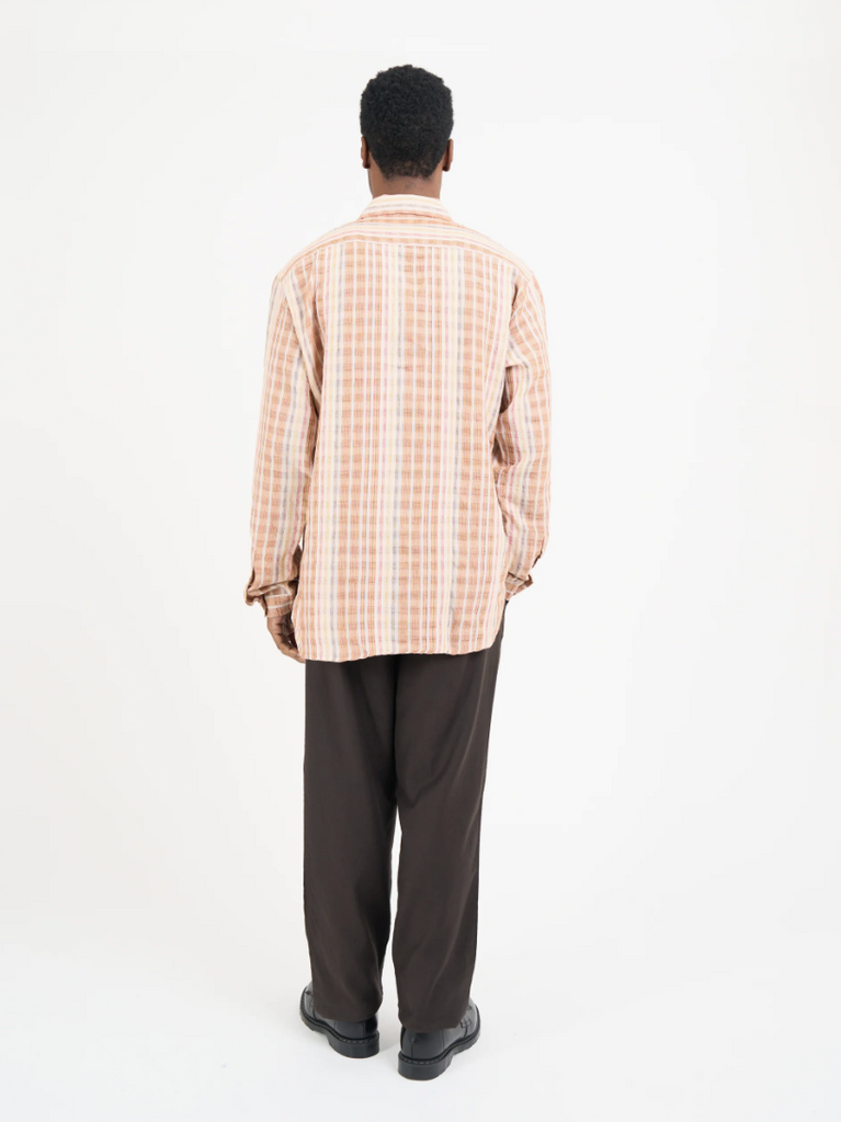 Multi-colored oversized long-sleeve shirt in lightweight cotton-linen seersucker, featuring a spear collar, front patch pocket, curved hem, and contrast gusset.