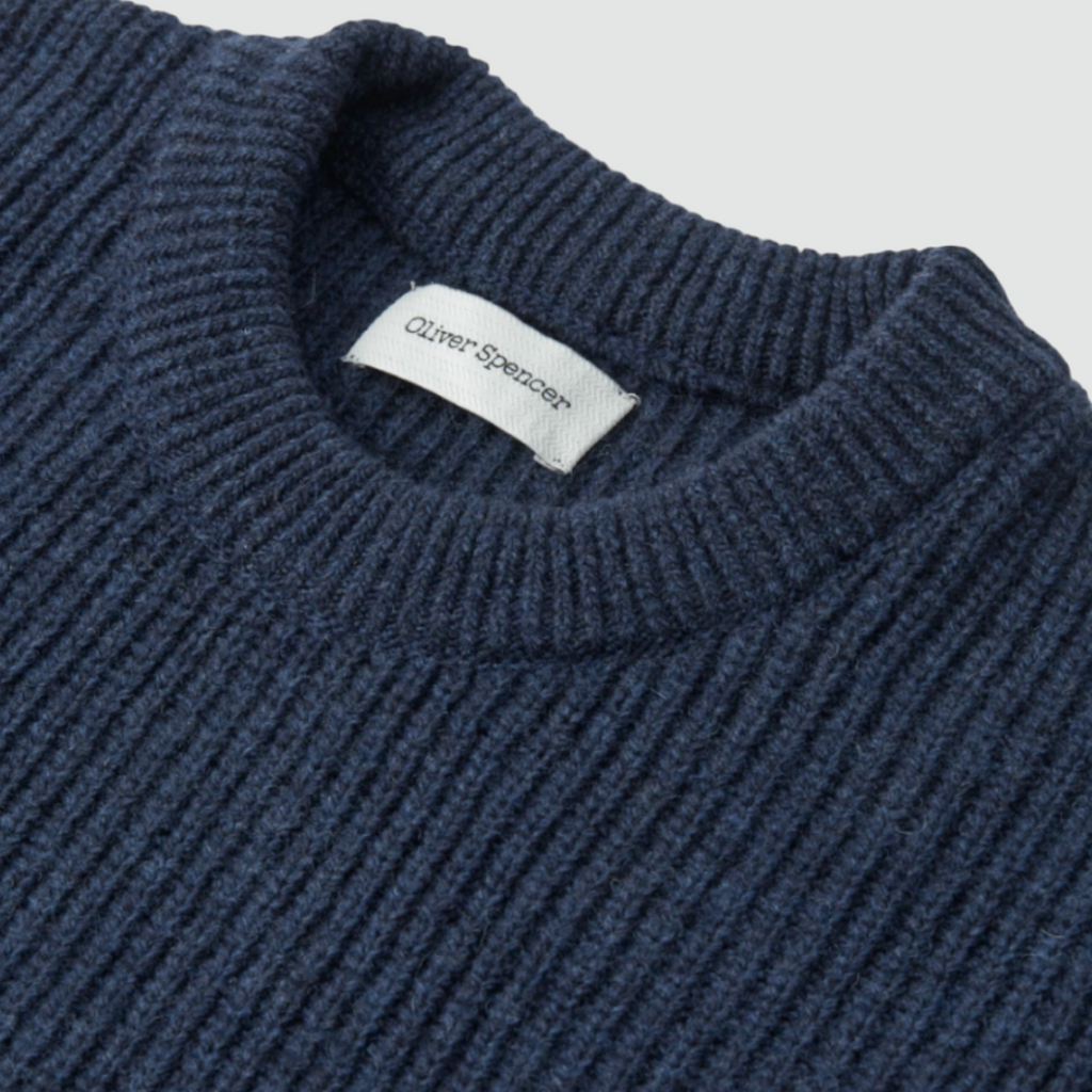 A navy jumper made from 100% extrafine wool with ribbed details, a chest pocket, and a regular fit, featuring a double-faced contrast neck-ringer.