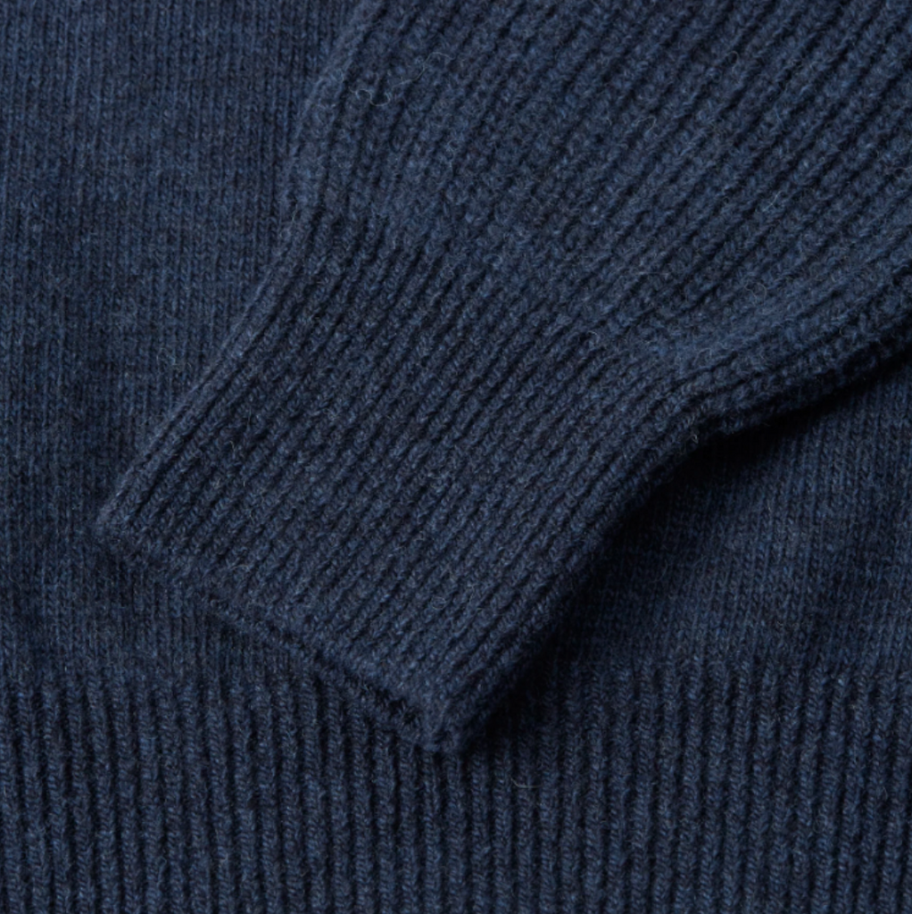 A navy jumper made from 100% extrafine wool with ribbed details, a chest pocket, and a regular fit, featuring a double-faced contrast neck-ringer.