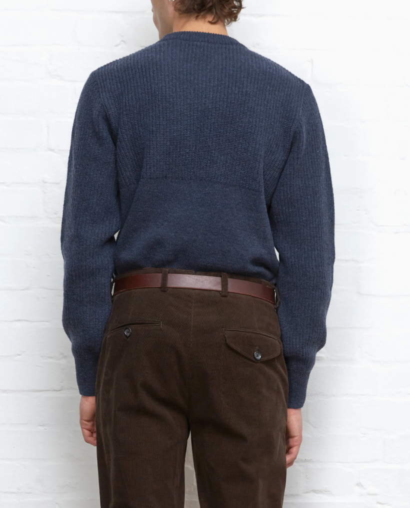 A navy jumper made from 100% extrafine wool with ribbed details, a chest pocket, and a regular fit, featuring a double-faced contrast neck-ringer.