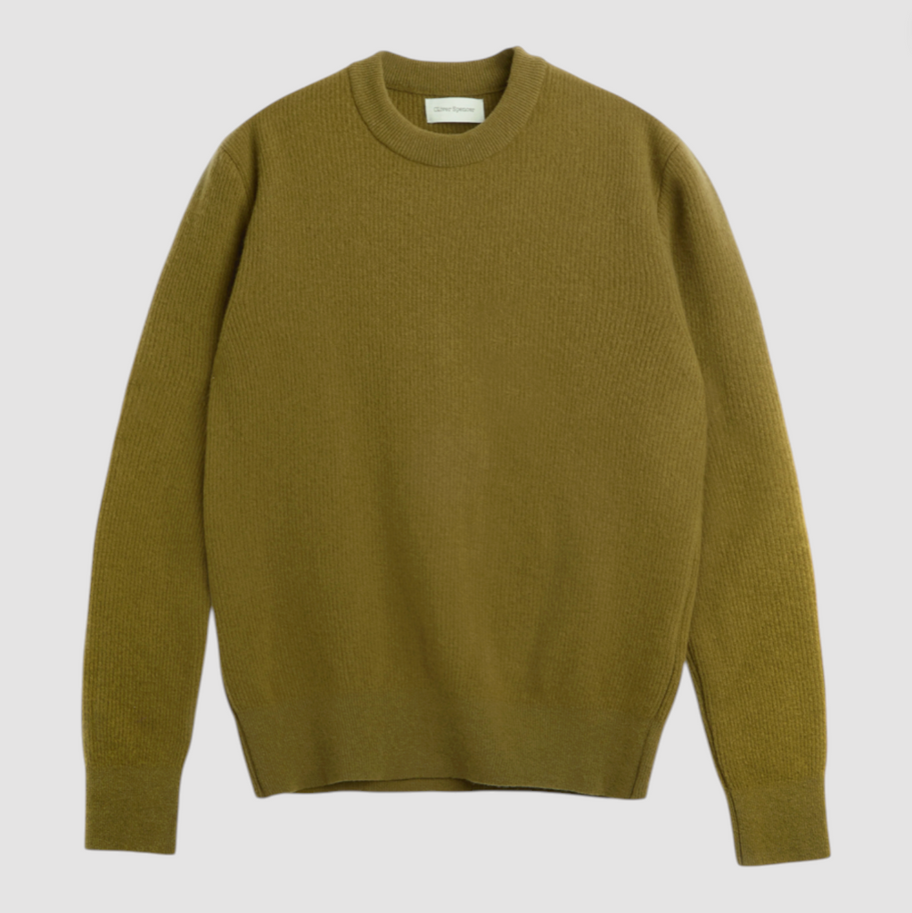 Green sweater on a light gray background.