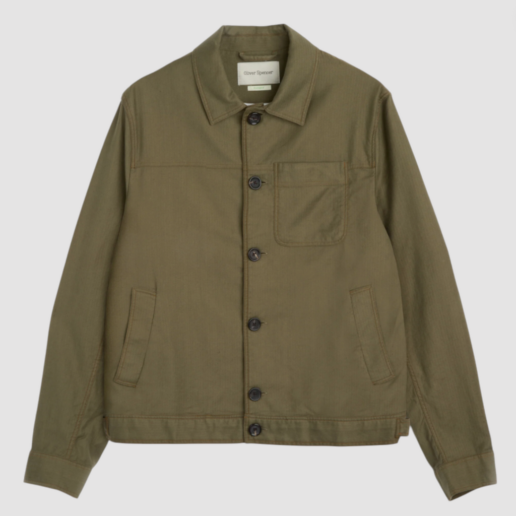 A green trucker jacket in a linen-cotton herringbone blend, featuring button fastening, welted pockets, and a chest patch pocket for a classic look.