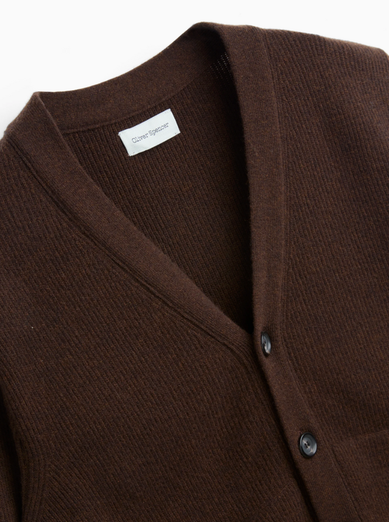 Knitted cardigan in Hartwell Brown made of extrafine wool, featuring a rib-knit texture, horn button closure, and a modern collarless silhouette.