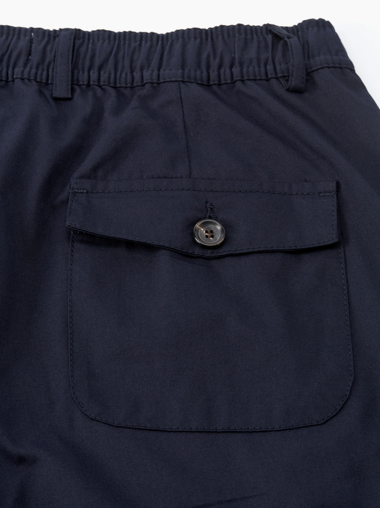 Navy blue pants with a button on a white background.