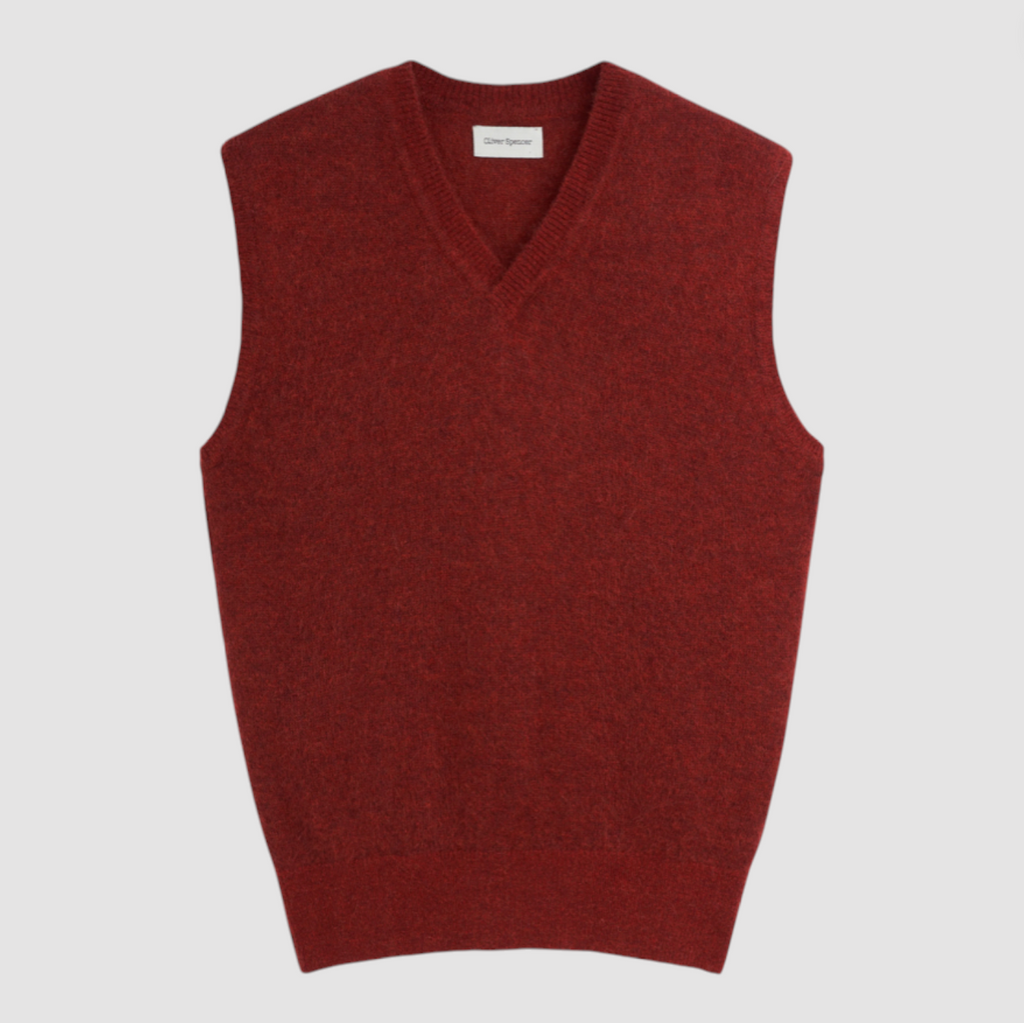 Red sweater vest on a light gray background.