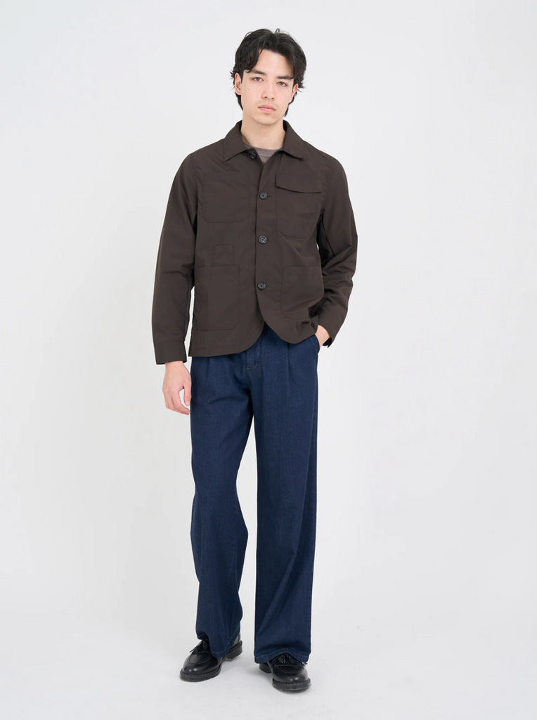 Man wearing a brown, lightweight chore jacket with front and rear patch pockets, ideal for spring layering.