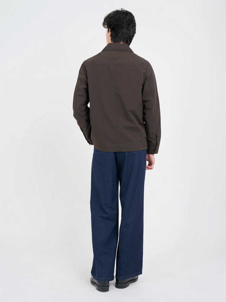 Man wearing a brown, lightweight chore jacket with front and rear patch pockets, ideal for spring layering.