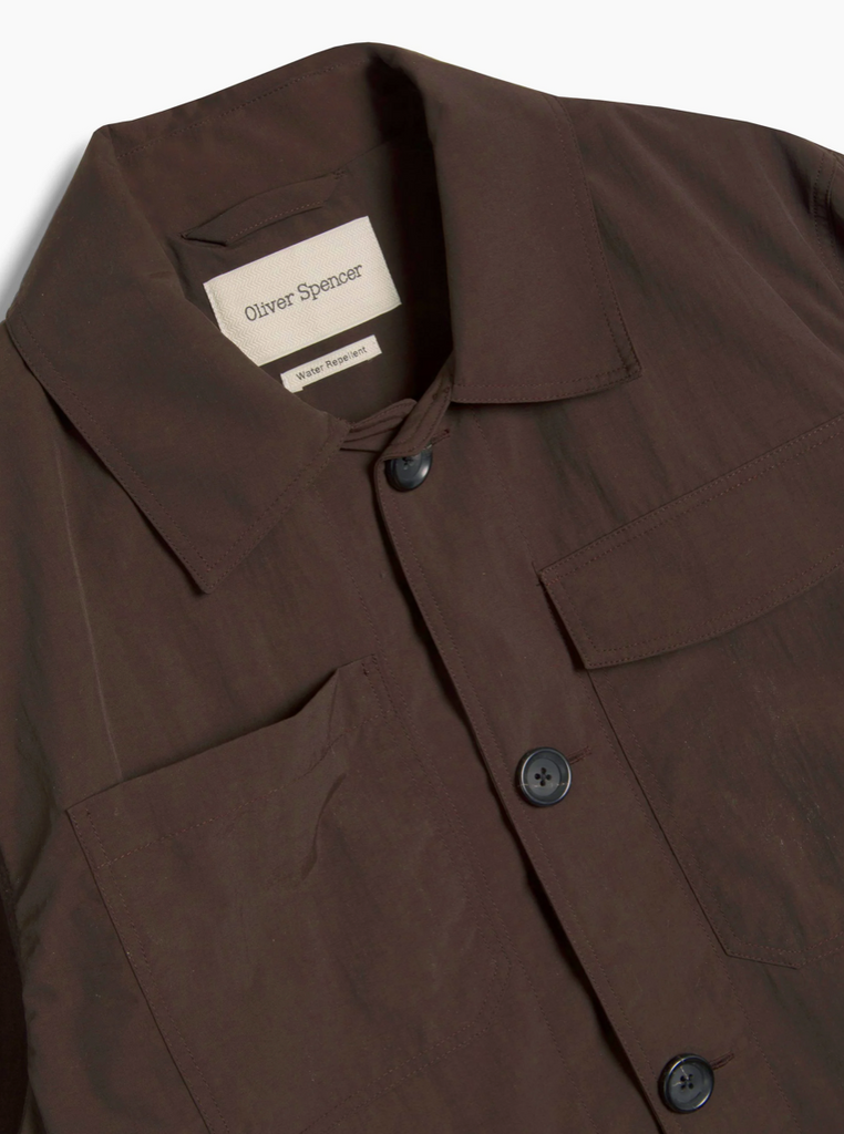 Brown jacket with a brand label on a white background