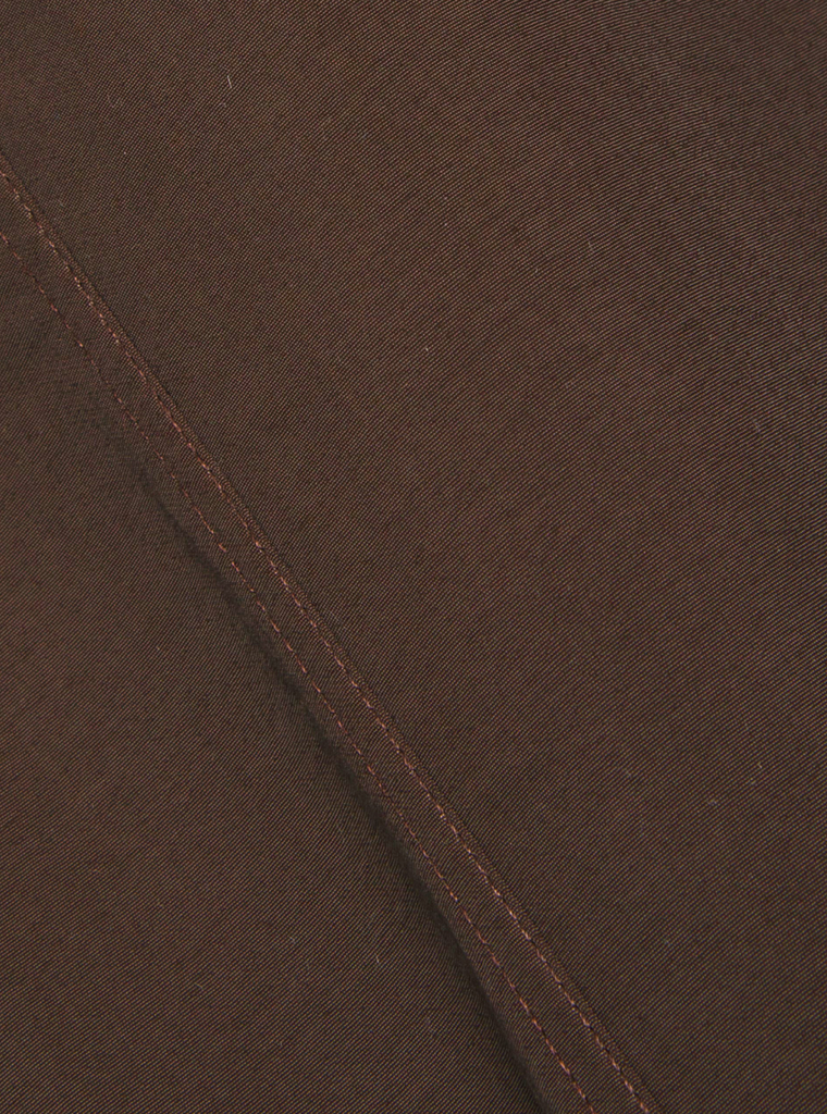 Close-up of brown fabric with a visible seam