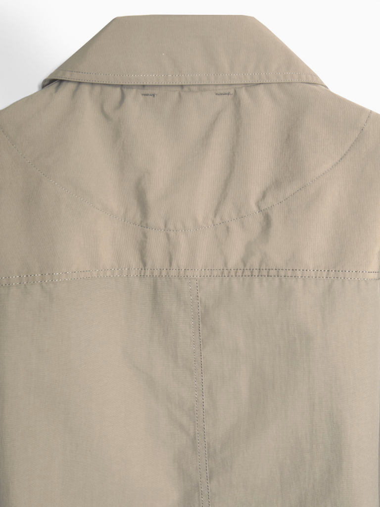 Khaki regular-fit chore jacket made from lightweight, water-repellent recycled polyamide, featuring multiple patch pockets and horn button closures.