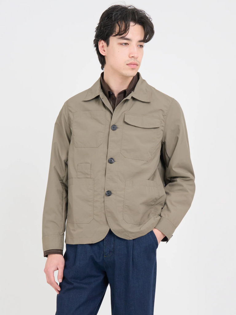 Khaki regular-fit chore jacket made from lightweight, water-repellent recycled polyamide, featuring multiple patch pockets and horn button closures.