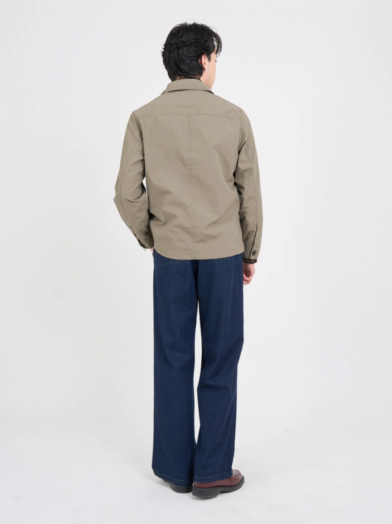 Khaki regular-fit chore jacket made from lightweight, water-repellent recycled polyamide, featuring multiple patch pockets and horn button closures.