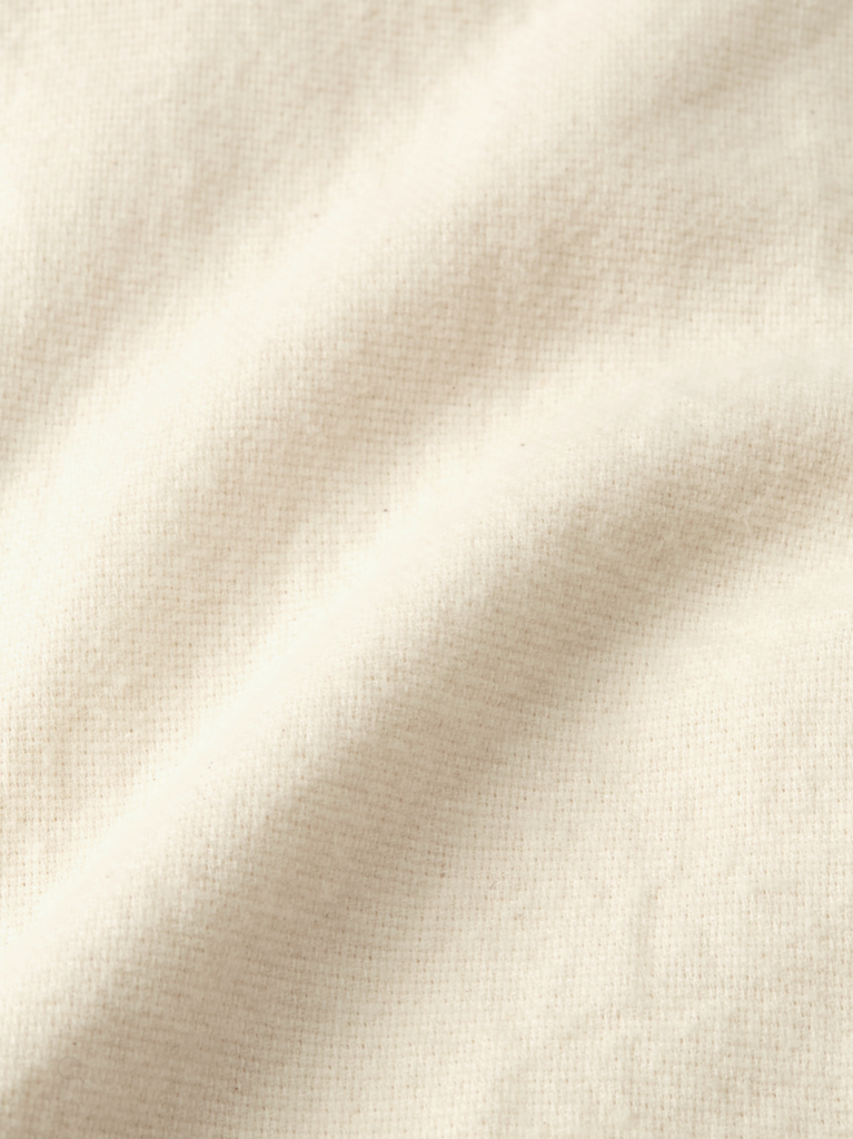 Close-up of cream fabric texture.