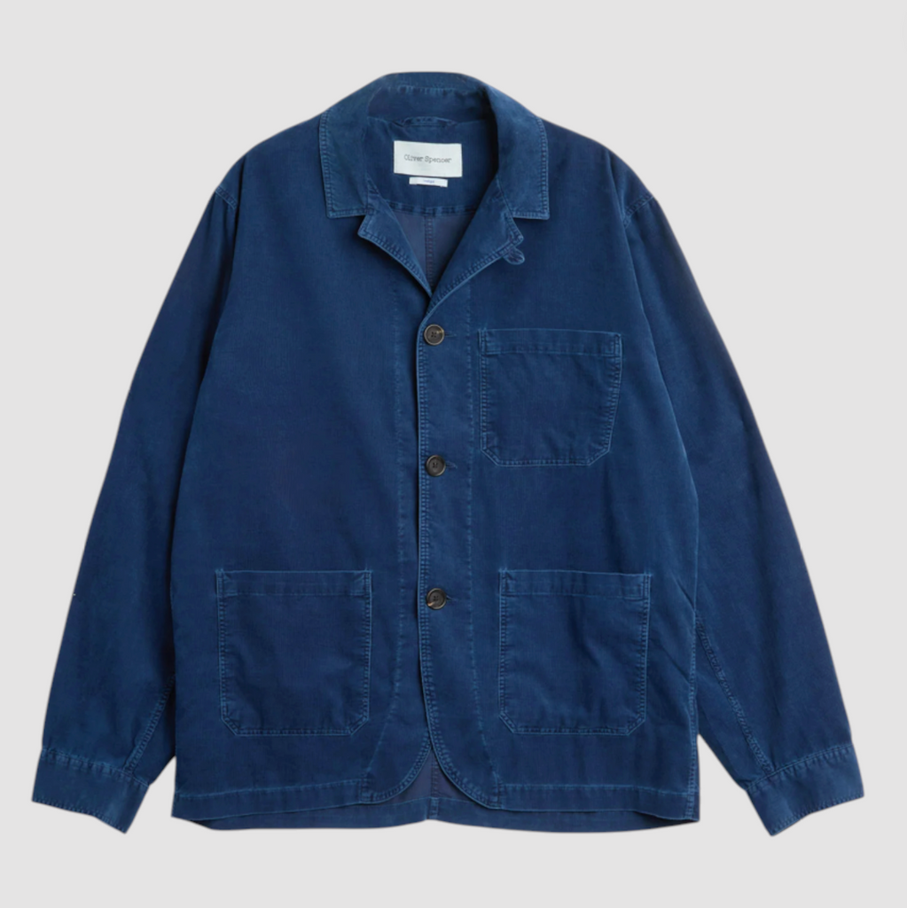 Blue corduroy jacket with button details on a light gray background.