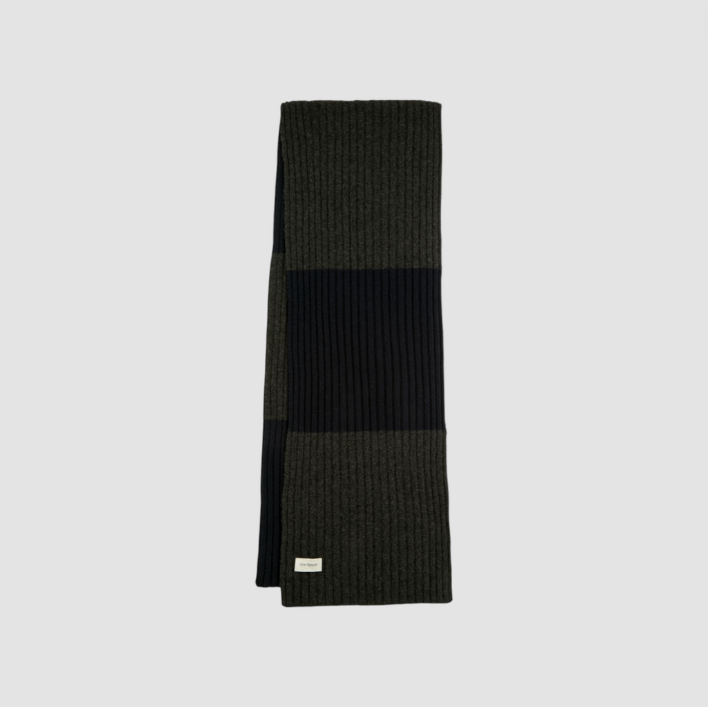 Navy and gray striped scarf on a light gray background.