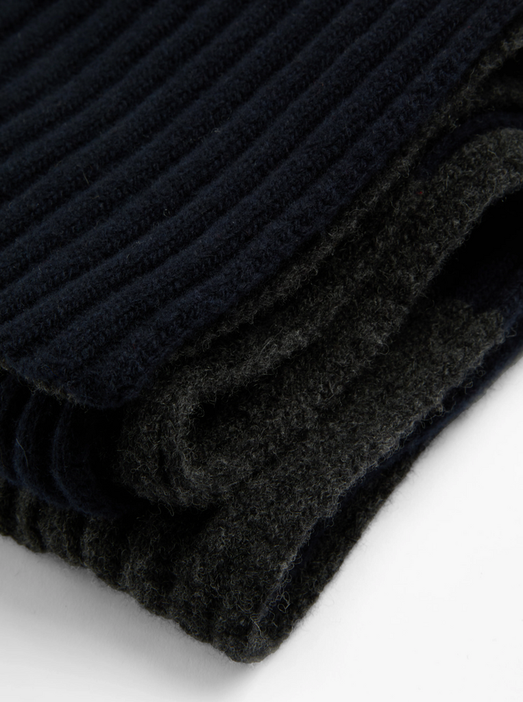 Close-up of a navy and grey ribbed knit scarf on a white background.