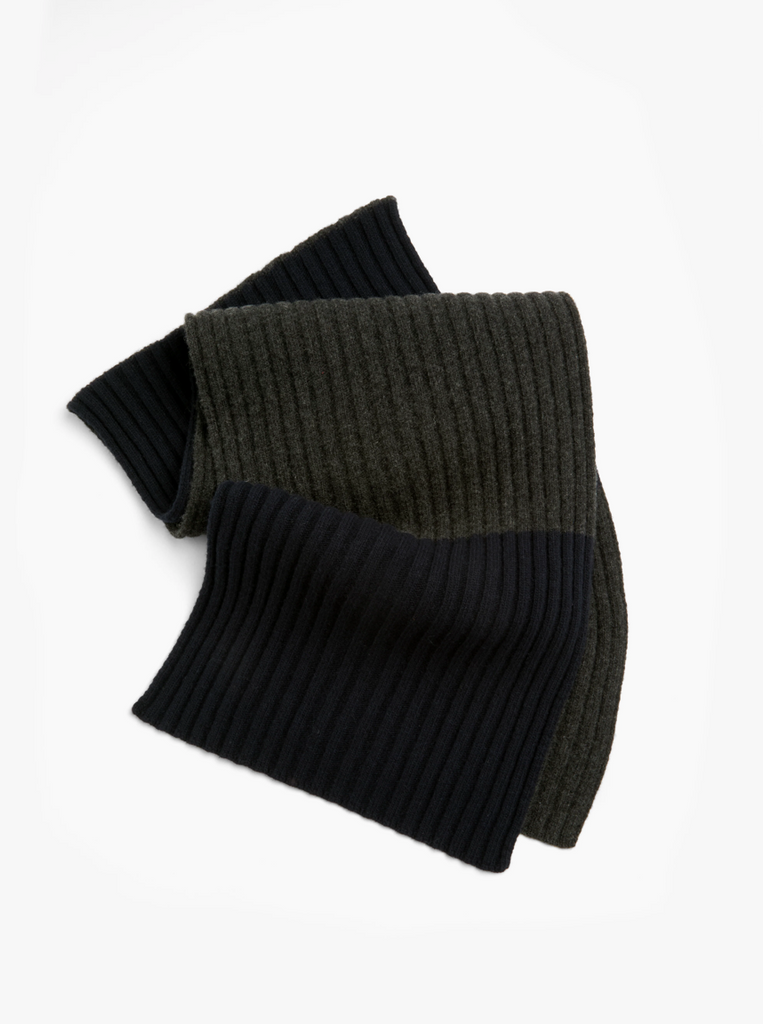 Navy and grey striped ribbed knit scarf on a white background.