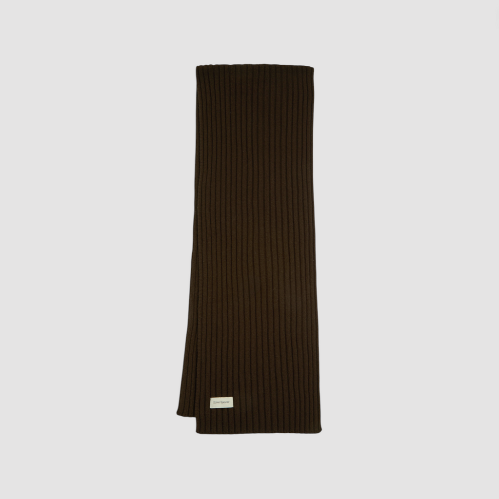 Dark ribbed knit scarf on a light gray background.