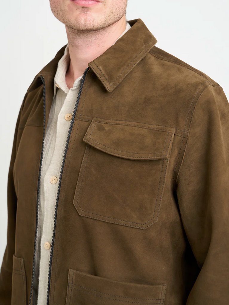 Brown suede jacket with a collar and front pocket on a white background.