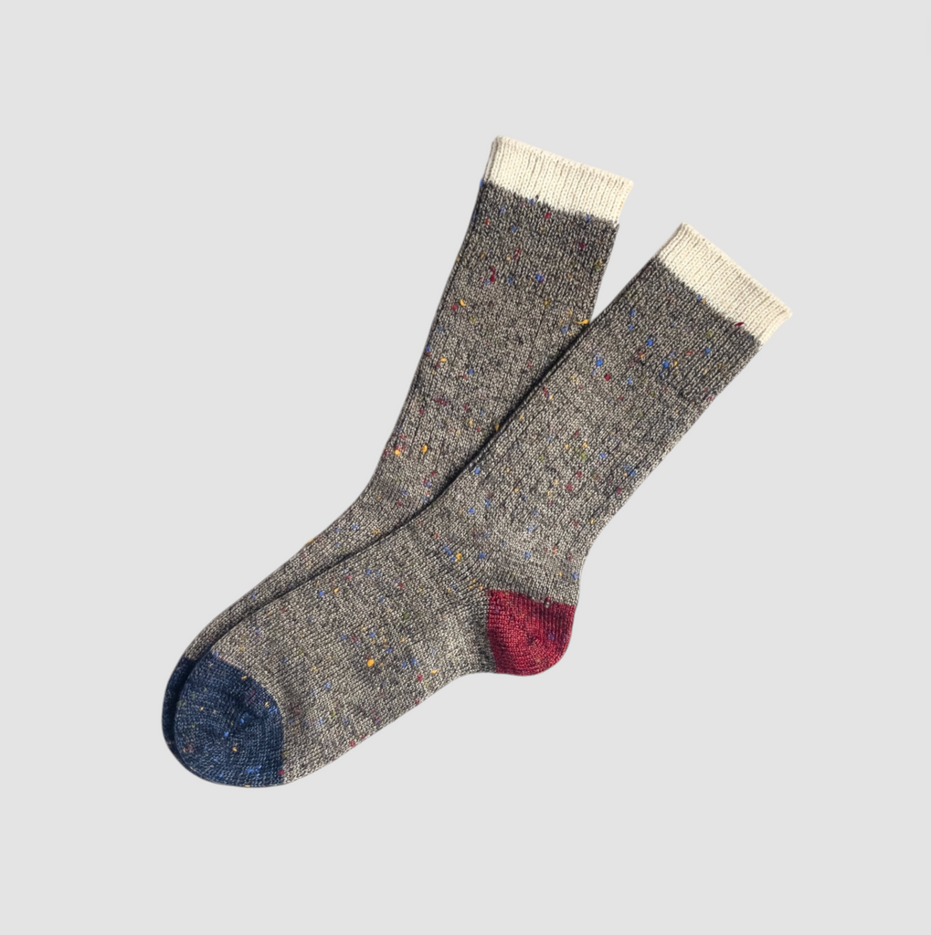 A pair of grey heavyweight socks with intricate celestial details, inspired by the moon.