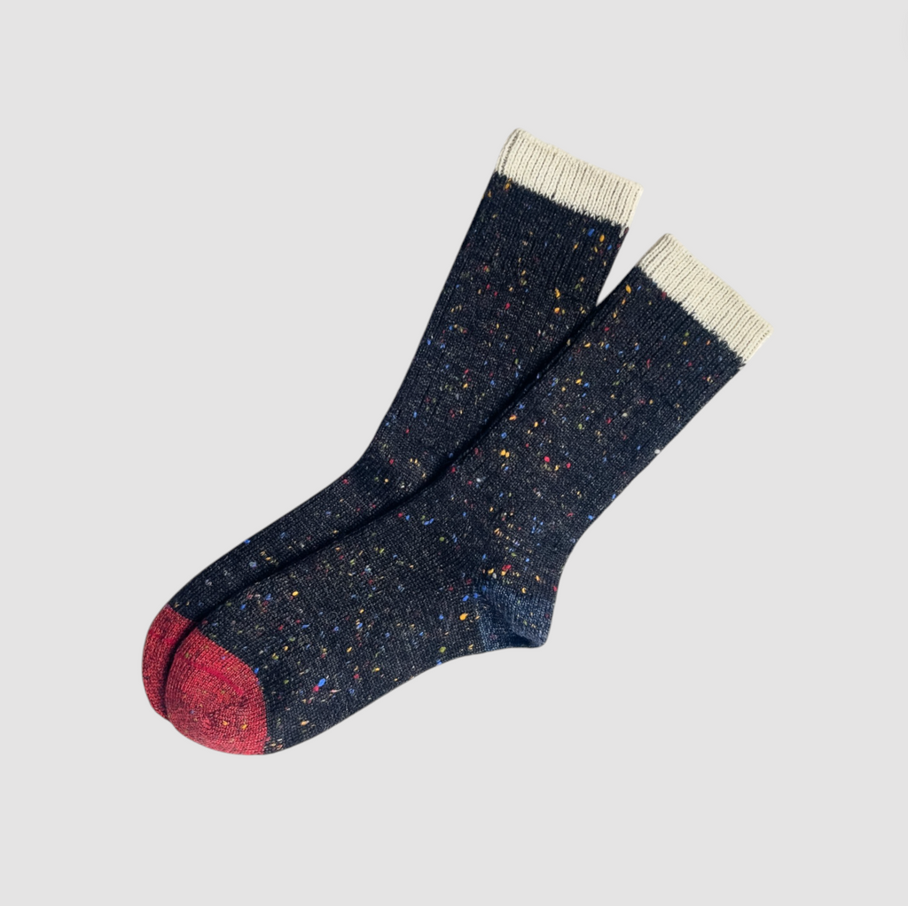 A pair of speckled alpaca wool socks, inspired by the night sky’s colors and textures.