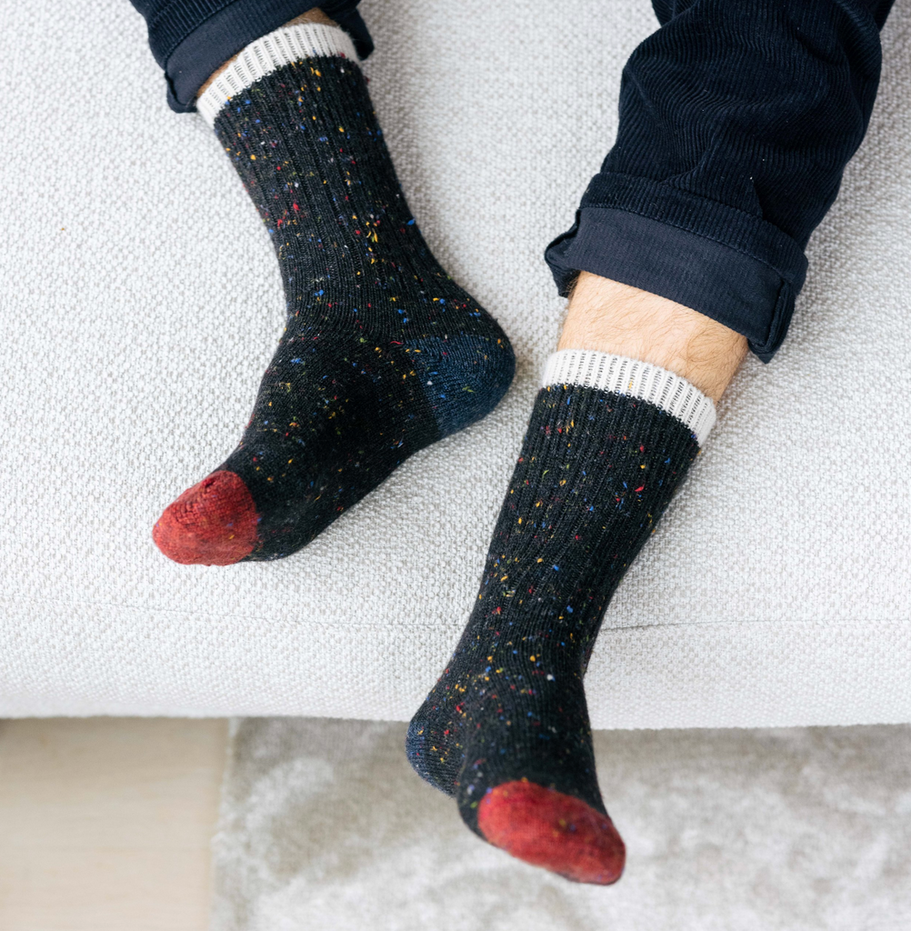 A pair of speckled alpaca wool socks, inspired by the night sky’s colors and textures.