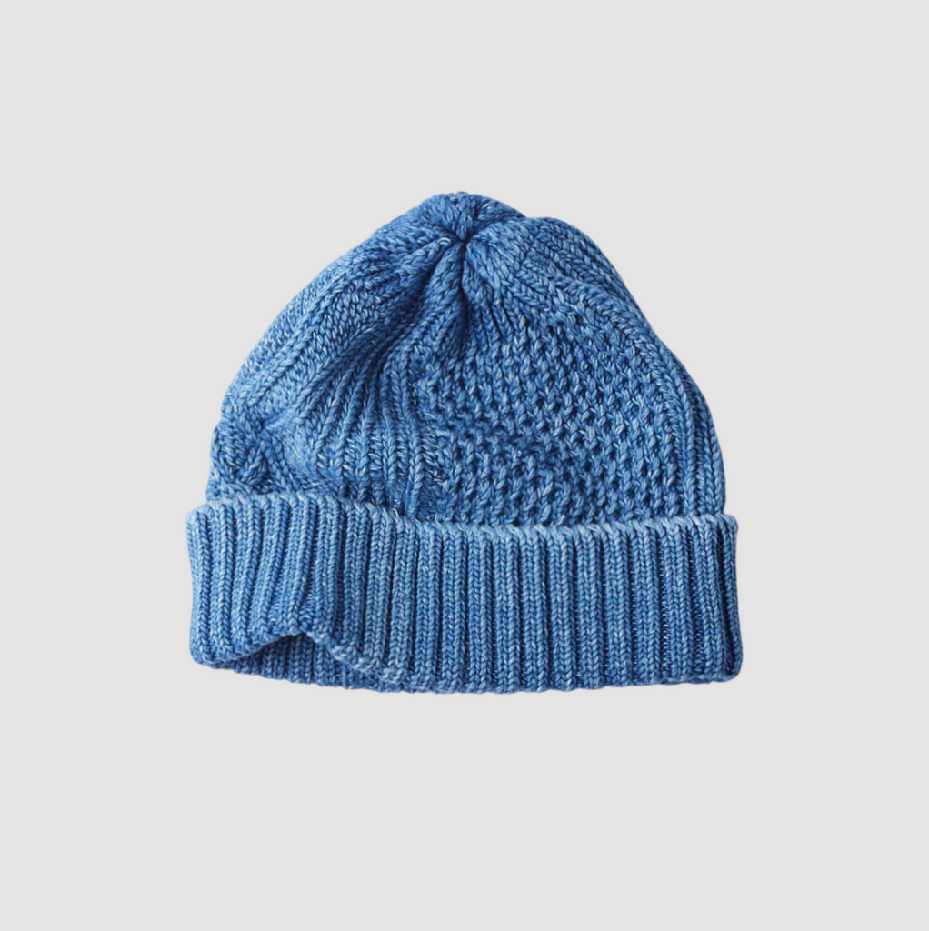 Light Blue Rototo Aran Cable Watch Cap, featuring 100% cotton construction and indigo-dyed yarn, inspired by traditional Aran knitting patterns.