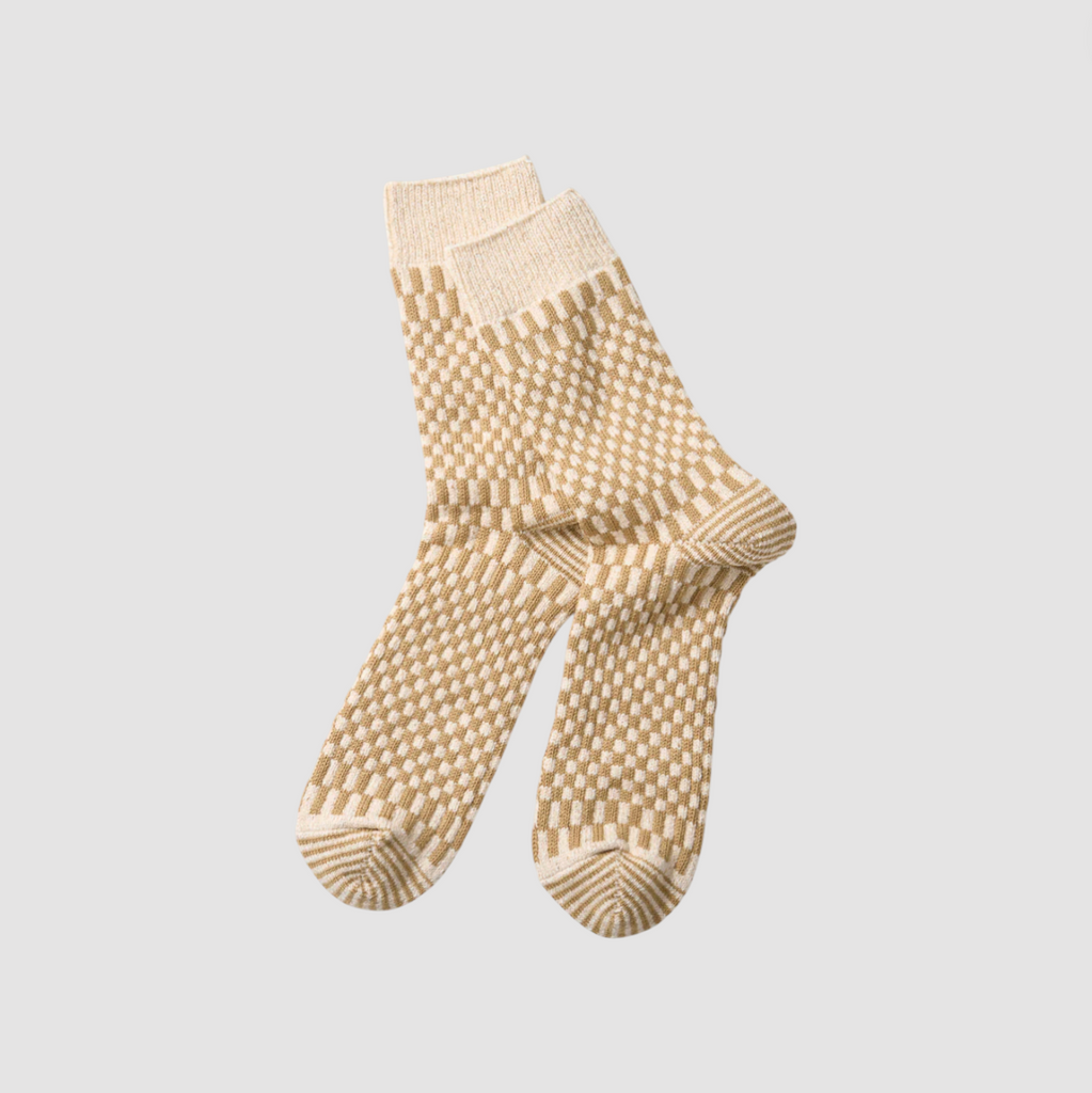 Pair of khaki textured socks on a light gray background.