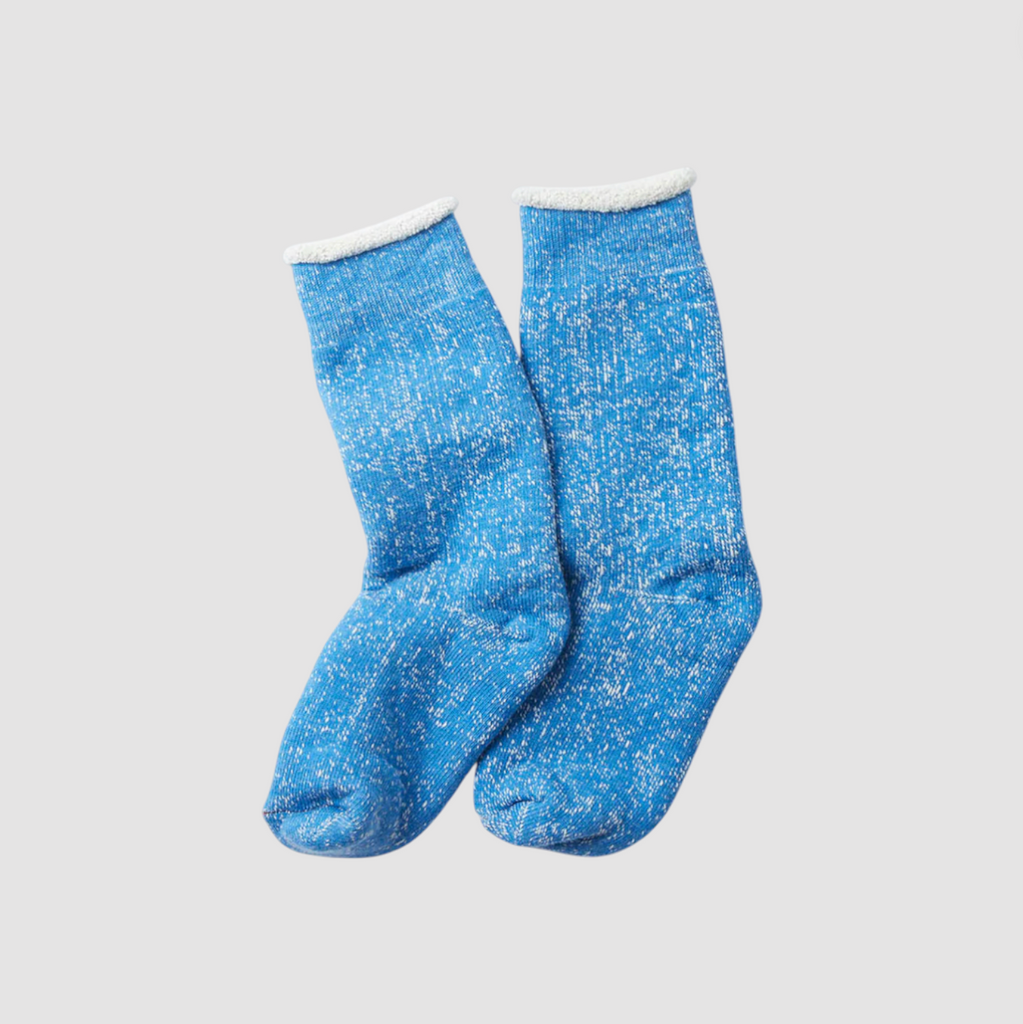 Blue socks on a light grey background. 