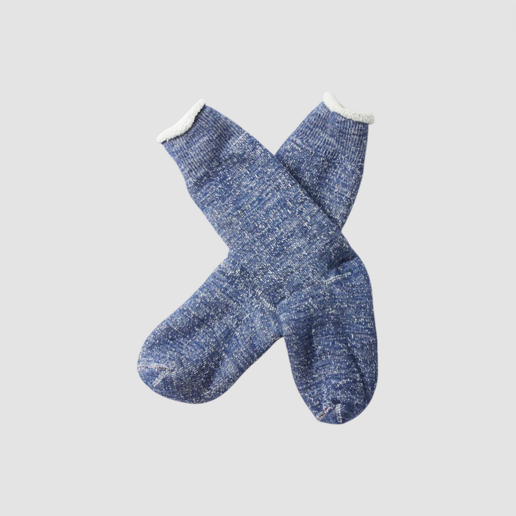 Pair of dark blue socks on a light gray background.