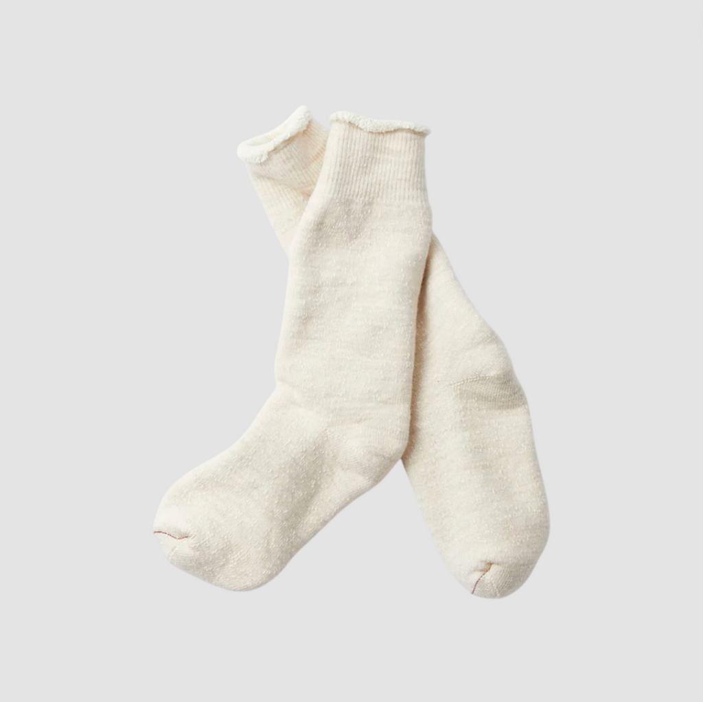 Pair of white socks on a light gray background