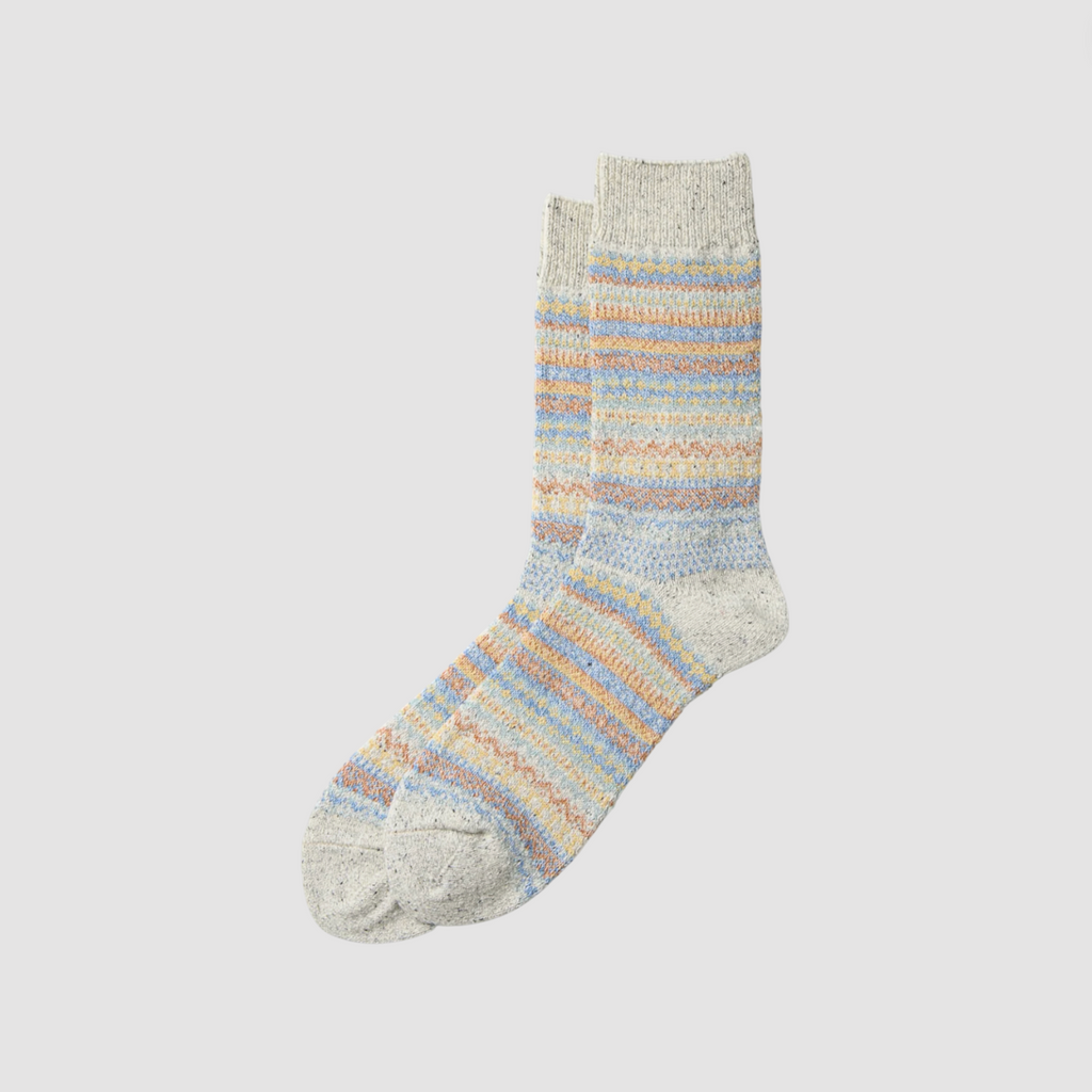 A pair of multicoloured patterned socks on a light grey background,