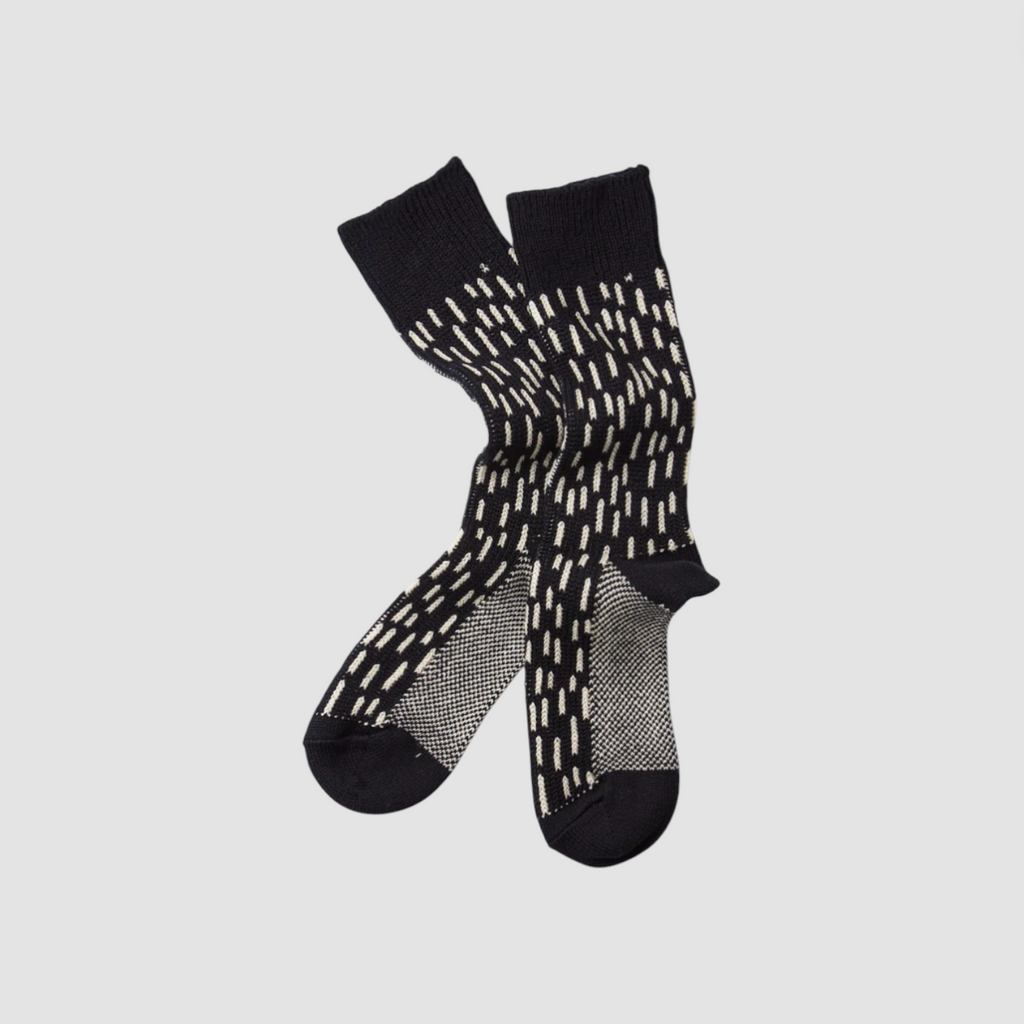 Black socks with white pattern on a light gray background