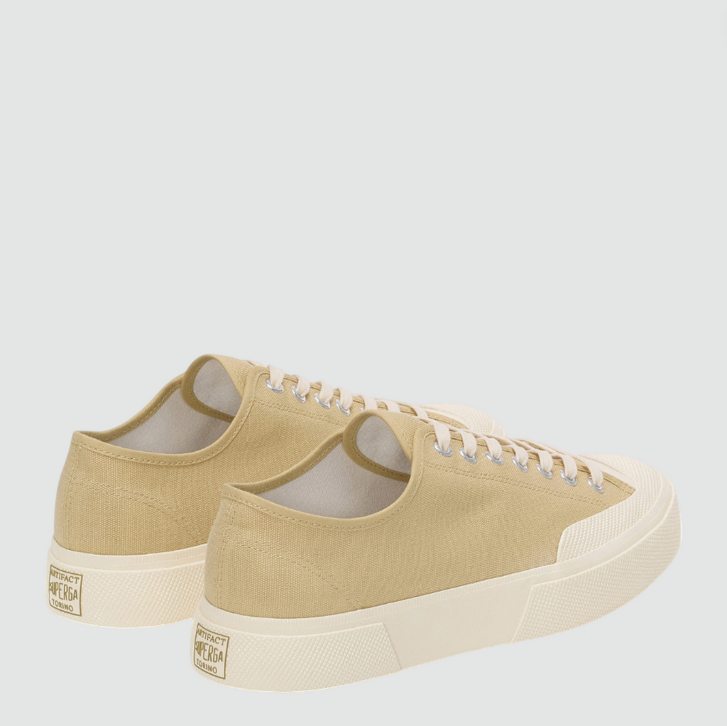 Beige low-top canvas sneaker with rubber toe cap, square toe, and vintage workwear-inspired details.