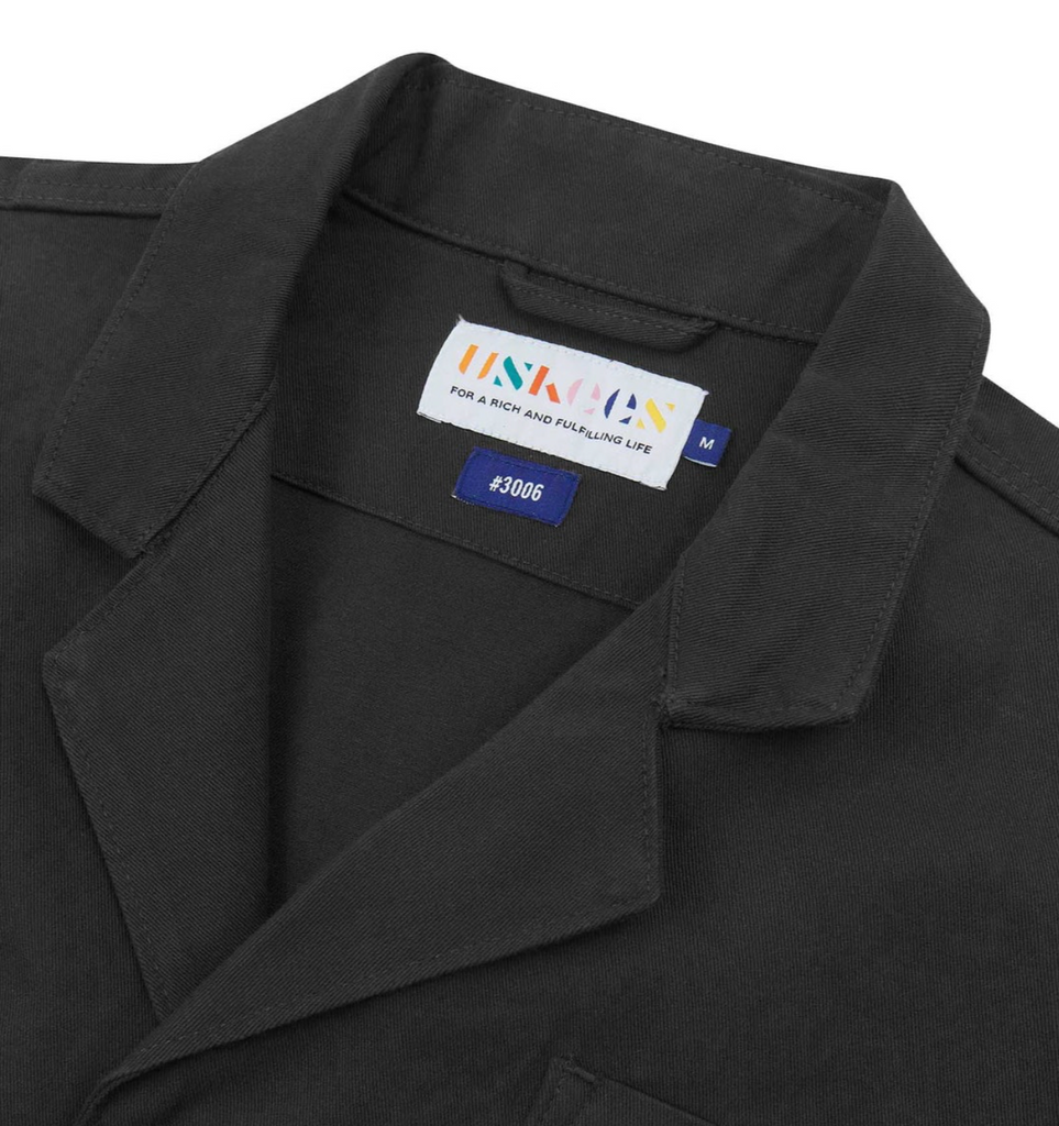 Grey blazer with a brand label on the collar.