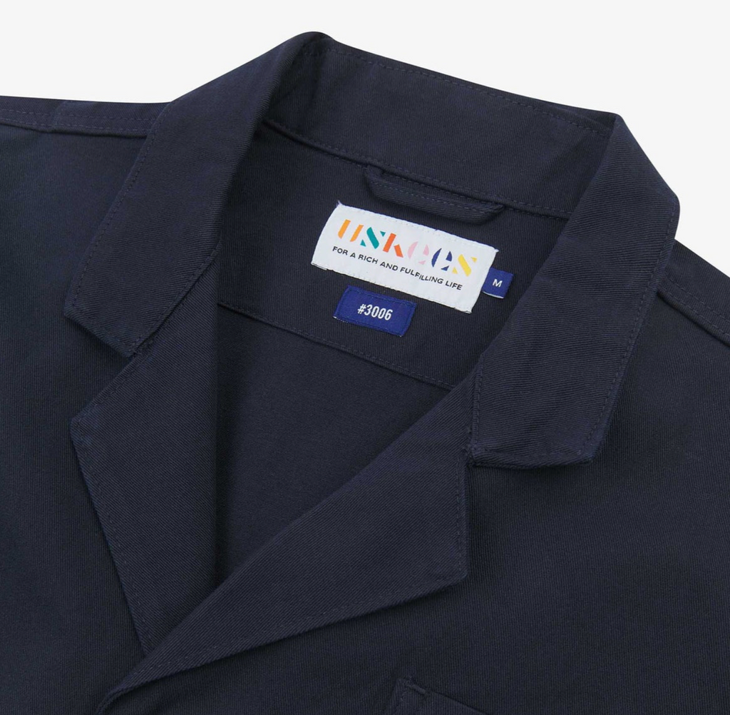 Navy blazer with a brand label on a white background.