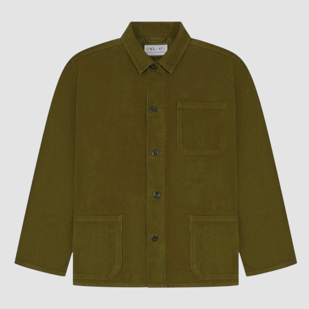 Green corduroy jacket with button details on a light gray background.