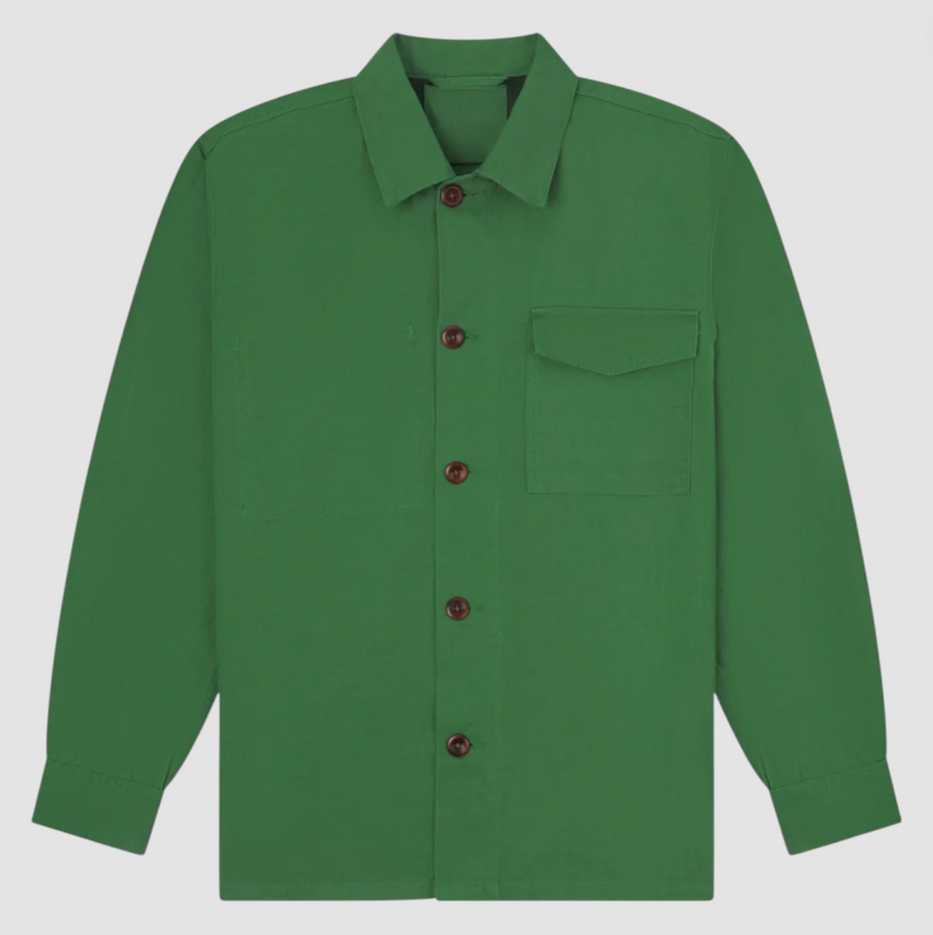 Mint green buttoned workshirt with a utilitarian fit, organic cotton fabric, chest pockets, reinforced elbows, and contrast-lined yoke and cuffs in dark blue.