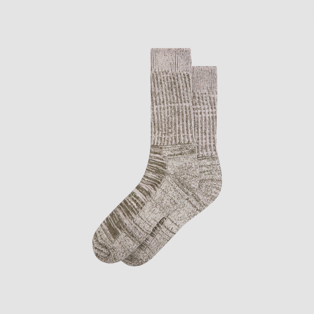 Pair of green and ecru socks on a light gray background.