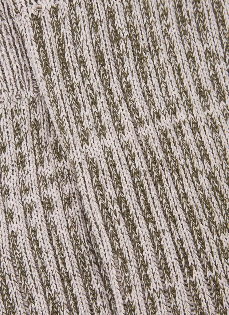 Close-up of a textured sock in green and ecru.