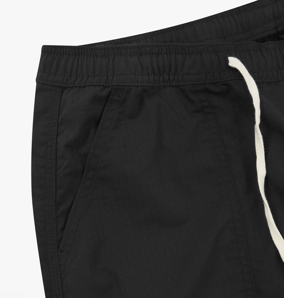 Black pants with a white drawstring on a light gray background.