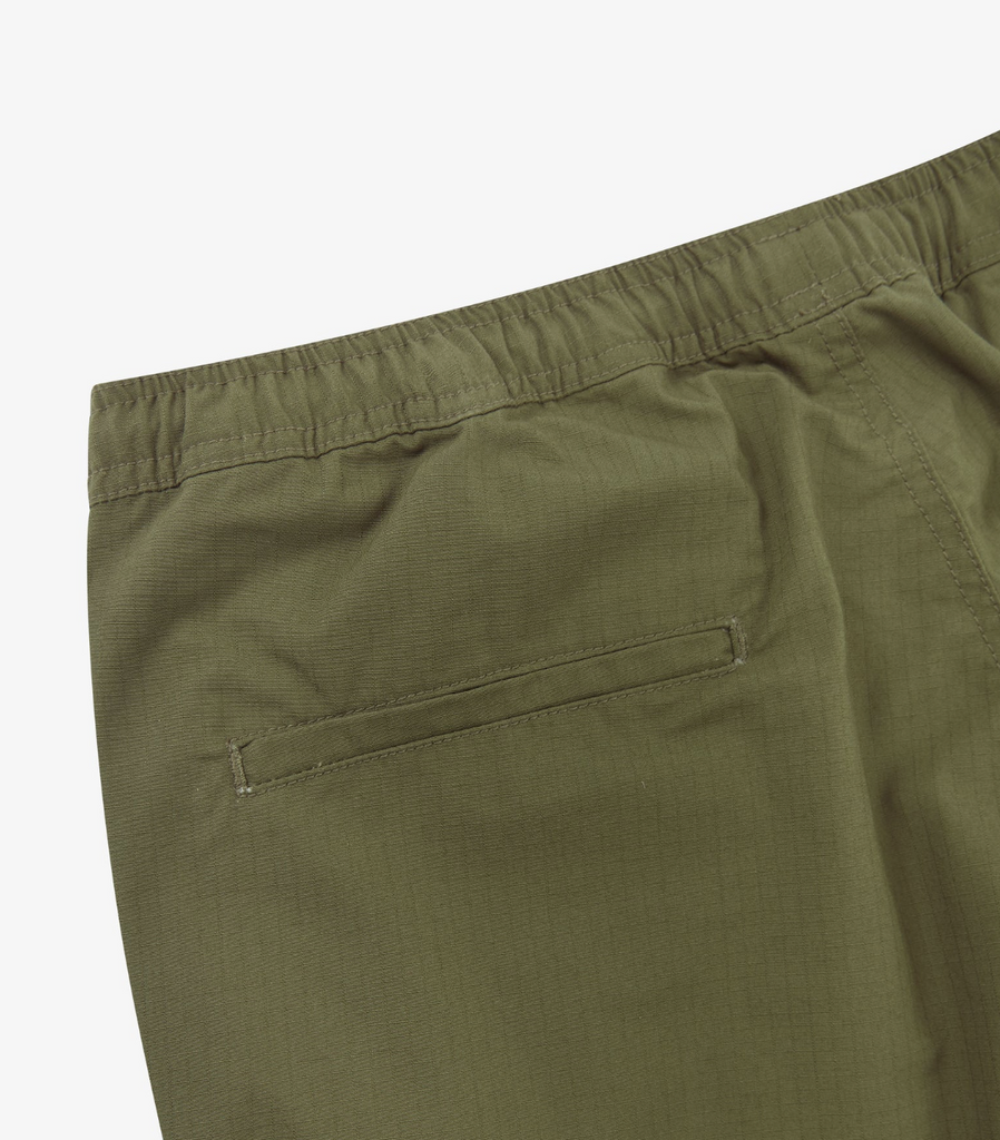 Close-up of green pants on a white background.